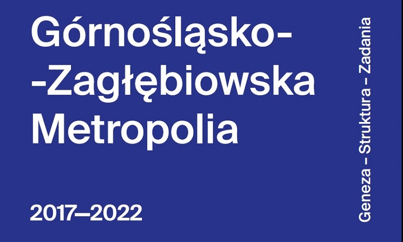 Granatowa plansza. Napis biały Górnośląsko - Zagłębiowska Metropolia 2017 - 2022